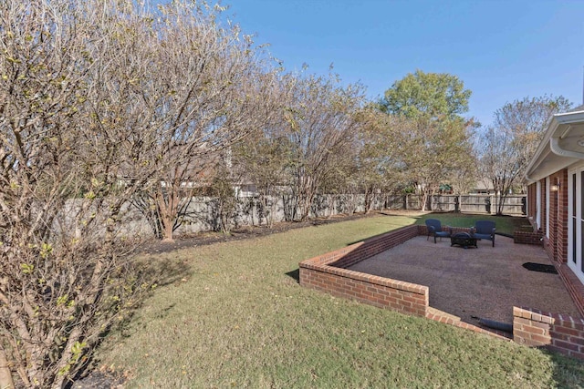 view of yard featuring a patio, a fenced backyard, and an outdoor fire pit