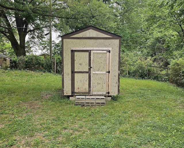 view of shed featuring fence
