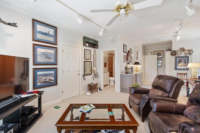 living area with light colored carpet, rail lighting, a ceiling fan, and crown molding
