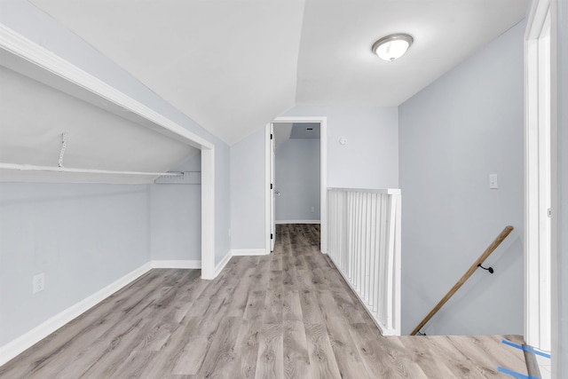 bonus room with baseboards, wood finished floors, and lofted ceiling