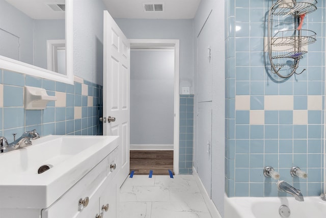 bathroom featuring visible vents, marble finish floor, shower / bath combination, and vanity