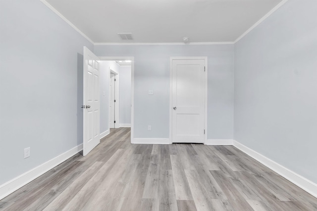unfurnished bedroom with baseboards, ornamental molding, and light wood finished floors