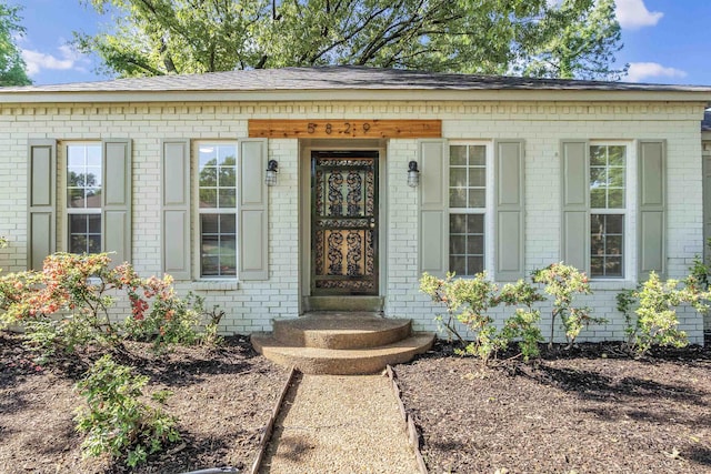 property entrance with brick siding