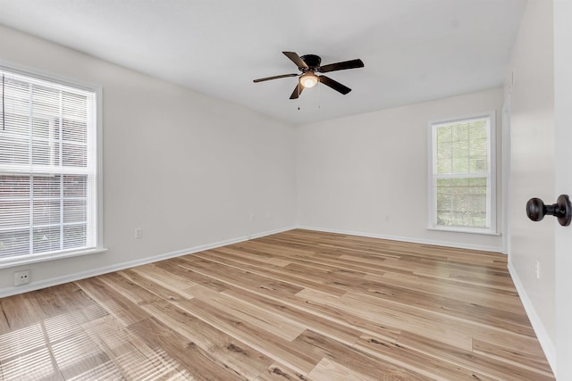 spare room featuring ceiling fan, baseboards, and light wood-style floors