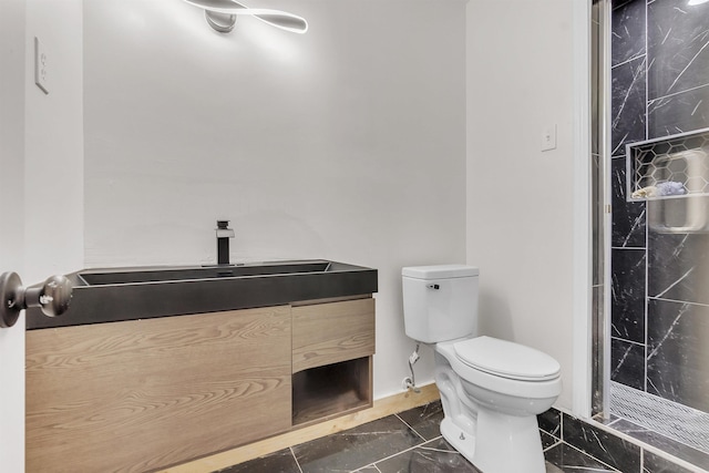 bathroom featuring a walk in shower, marble finish floor, toilet, and vanity