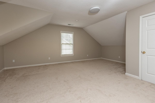bonus room featuring baseboards, visible vents, carpet flooring, and lofted ceiling