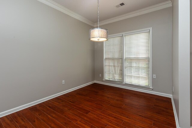 unfurnished room featuring visible vents, baseboards, and crown molding