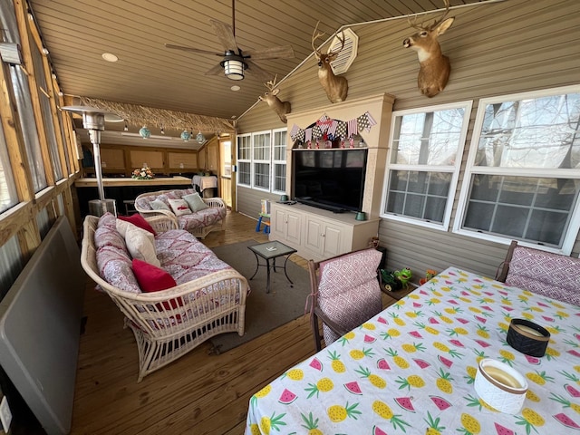 sunroom / solarium with a ceiling fan, outdoor lounge area, and plenty of natural light