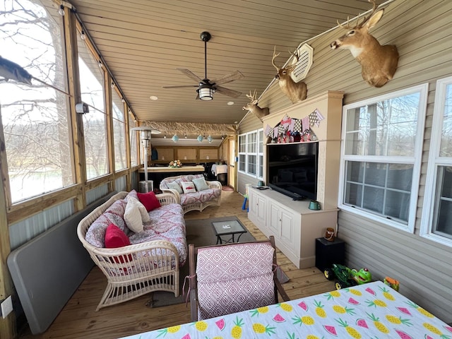 sunroom / solarium with ceiling fan, outdoor lounge area, and plenty of natural light