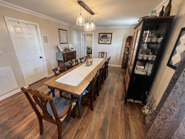 dining area with visible vents, ornamental molding, dark wood finished floors, and baseboards