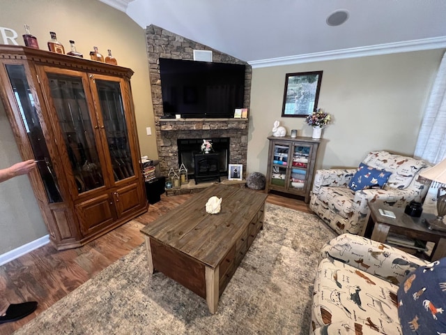 living area with ornamental molding, wood finished floors, and vaulted ceiling
