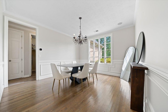 9842 Garden Pl, Collierville, TN 38139 - dining space featuring an inviting chandelier, ornamental molding, visible vents, and a decorative wall