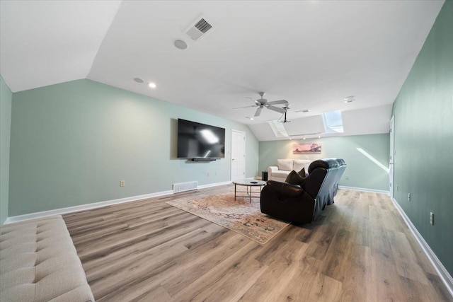 9842 Garden Pl, Collierville, TN 38139 - living room with visible vents, ceiling fan, and vaulted ceiling with skylight