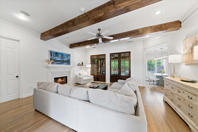 9842 Garden Pl, Collierville, TN 38139 - living area featuring wood finished floors, beamed ceiling, a lit fireplace, recessed lighting, and a ceiling fan