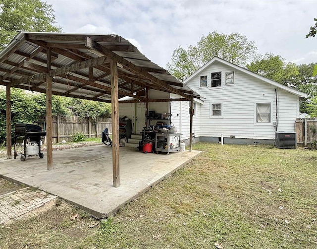 view of patio with central air condition unit, fence, grilling area, and a detached carport