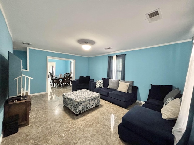 living area with visible vents, baseboards, and crown molding
