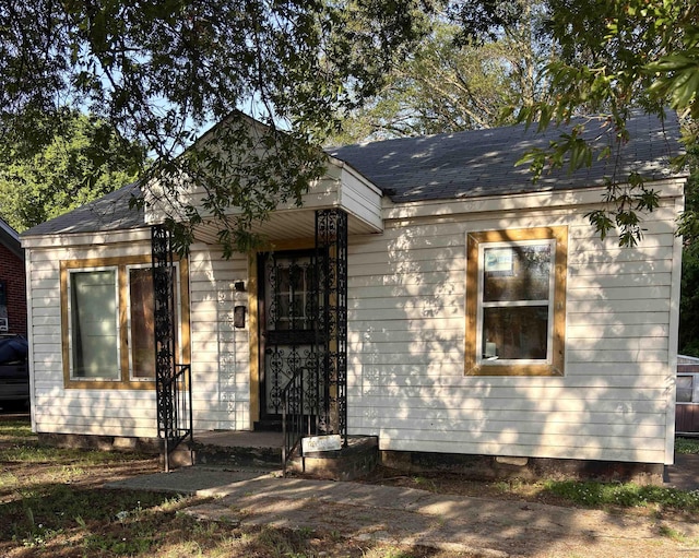 view of front of property featuring roof with shingles