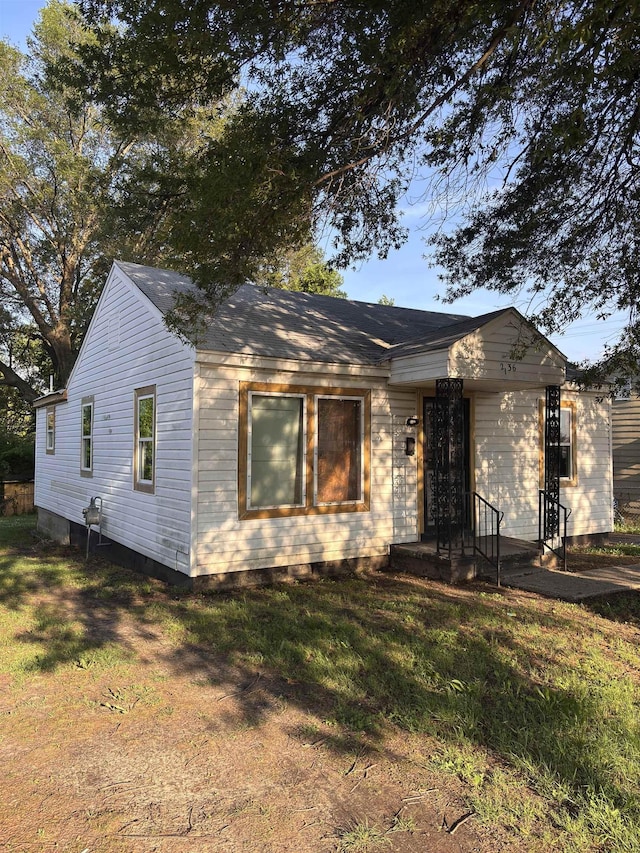 bungalow with a front yard