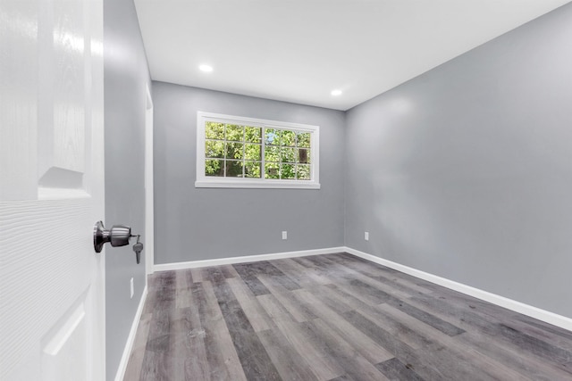 unfurnished room with recessed lighting, baseboards, and wood finished floors