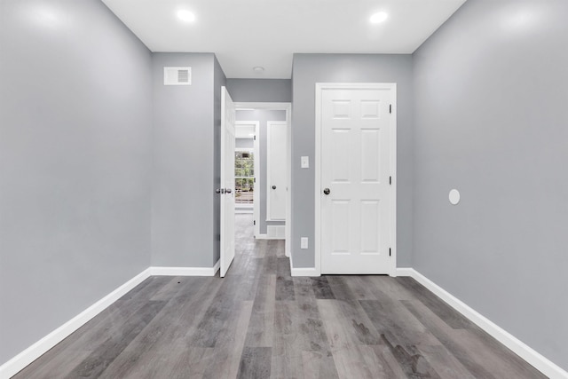 interior space featuring recessed lighting, baseboards, visible vents, and wood finished floors