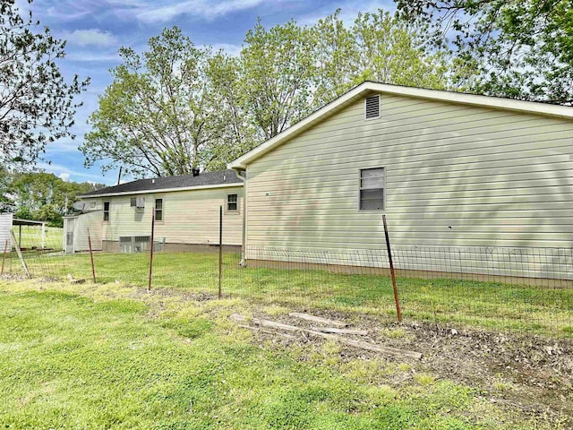 rear view of property featuring a yard