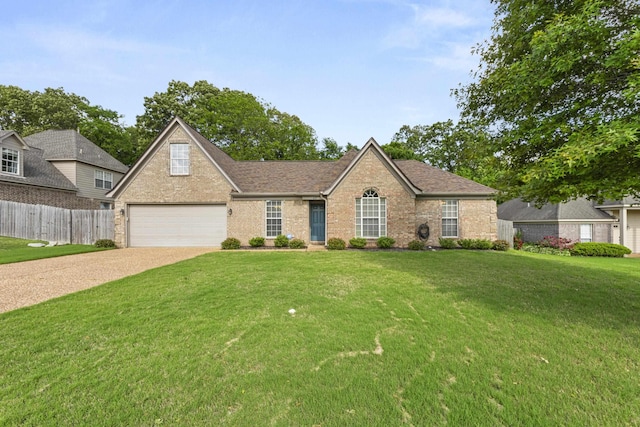 view of front of home featuring a garage, a front lawn, fence, brick siding, and concrete driveway