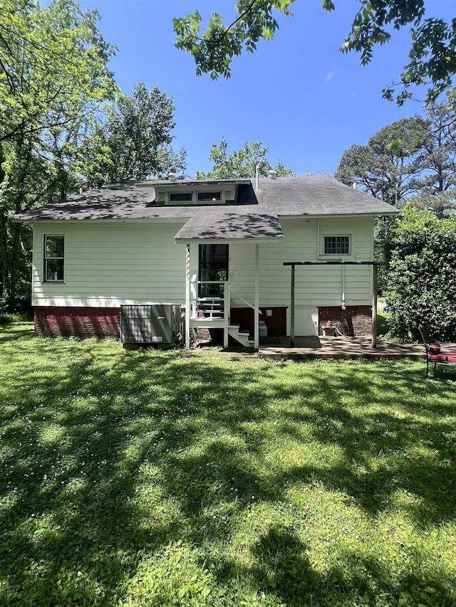 110 Shelton St, Covington, TN 38019 - rear view of house featuring a lawn and roof with shingles