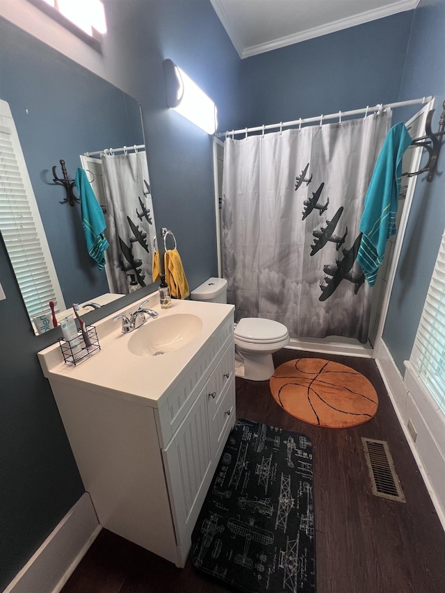 110 Shelton St, Covington, TN 38019 - bathroom with visible vents, crown molding, wood finished floors, vanity, and toilet