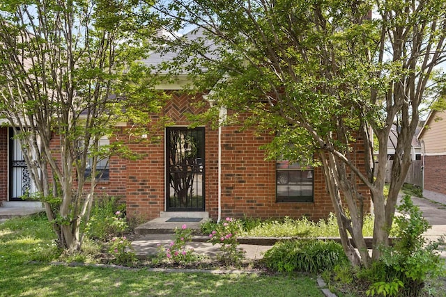 property entrance with brick siding