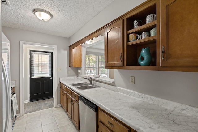 kitchen featuring open shelves, appliances with stainless steel finishes, a sink, light countertops, and visible vents
