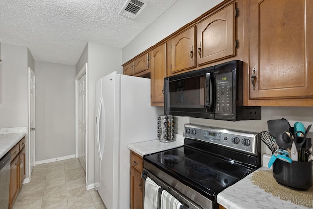 kitchen with light countertops, stainless steel appliances, brown cabinets, and visible vents