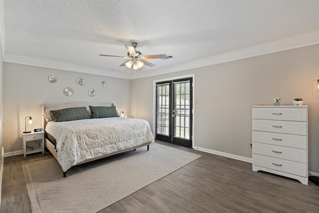 bedroom featuring crown molding, a textured ceiling, dark wood finished floors, and access to exterior