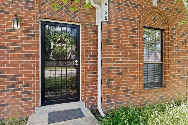 property entrance with brick siding