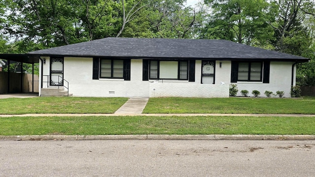 view of front of house with brick siding, a front lawn, and roof with shingles