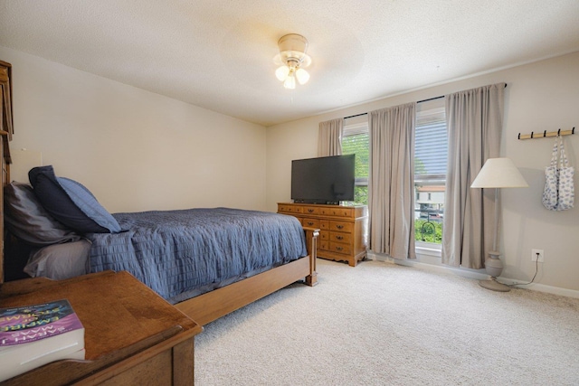 carpeted bedroom featuring baseboards