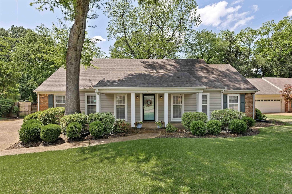2211 Burfordi Ln, Germantown, TN 38138 - view of front of home featuring brick siding, fence, a shingled roof, and a front lawn