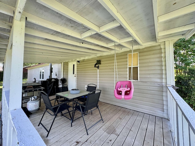wooden terrace featuring outdoor dining area