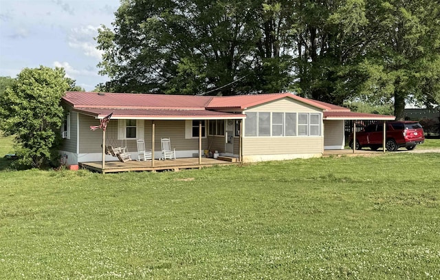 back of house featuring a lawn, metal roof, and a wooden deck