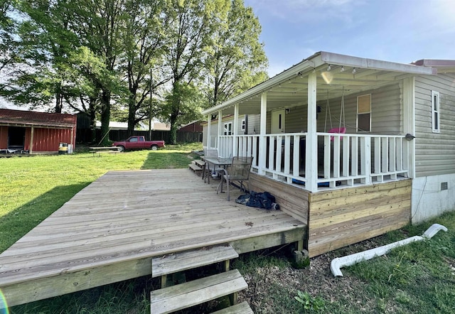 wooden terrace featuring a lawn
