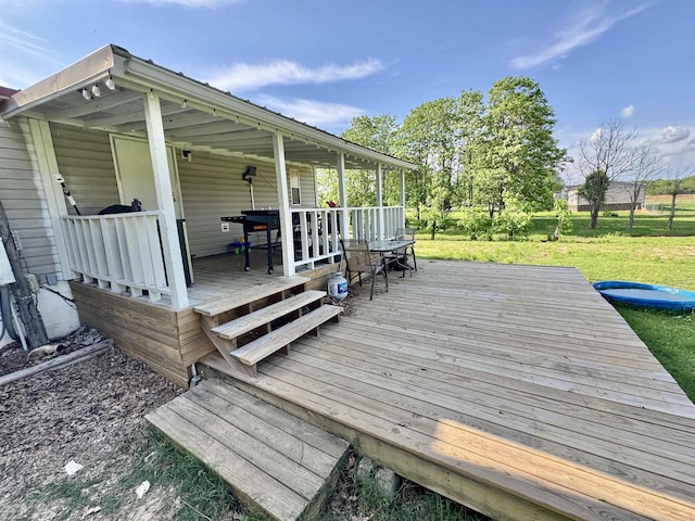 wooden terrace with a yard