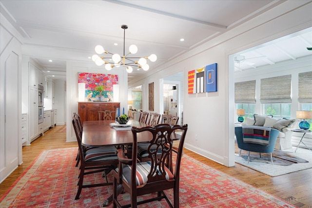 dining room with baseboards, light wood finished floors, and a wealth of natural light