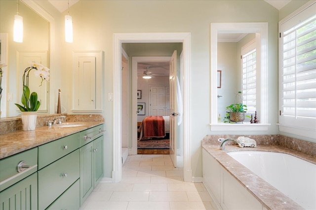 bathroom with ceiling fan, tile patterned flooring, ensuite bath, vanity, and a bath