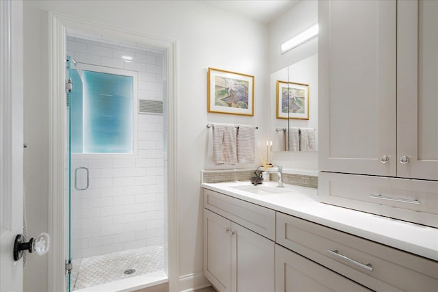 bathroom featuring a shower stall and vanity