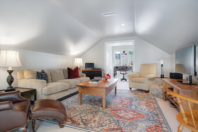 living room featuring visible vents, carpet, and lofted ceiling