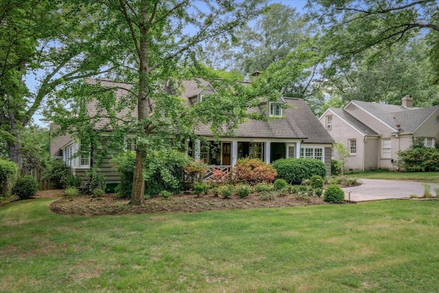 cape cod-style house with a front yard