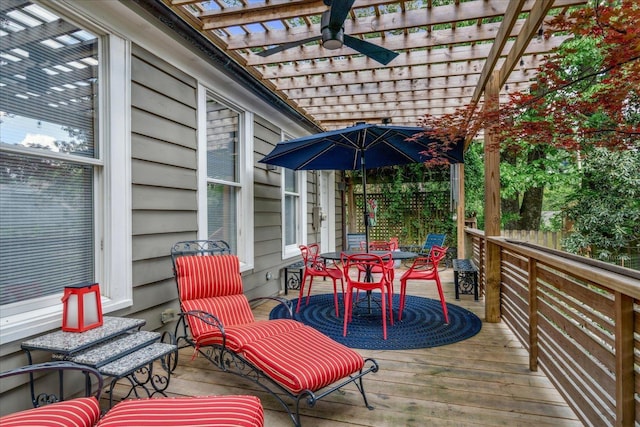 wooden deck featuring a pergola, outdoor dining area, and ceiling fan