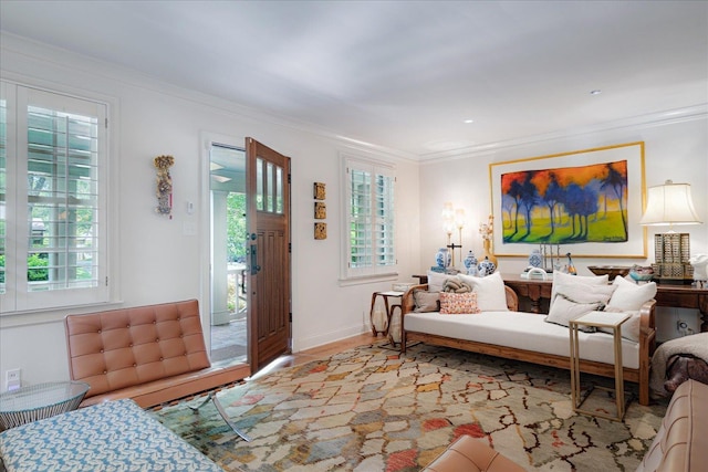living room featuring ornamental molding, wood finished floors, and a wealth of natural light