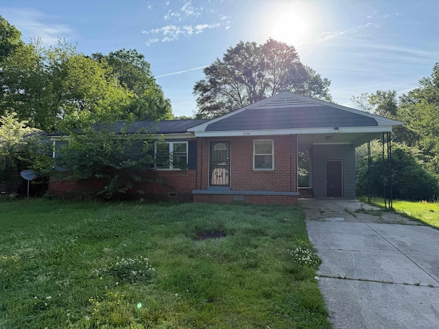 single story home with a carport, concrete driveway, brick siding, and a front yard