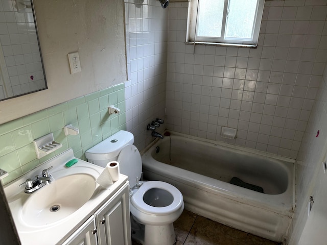 bathroom featuring shower / tub combination, tile patterned flooring, vanity, toilet, and tile walls
