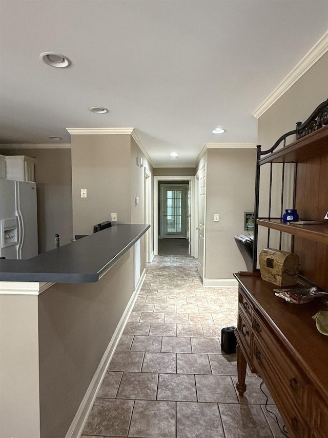 hall with baseboards, recessed lighting, and crown molding
